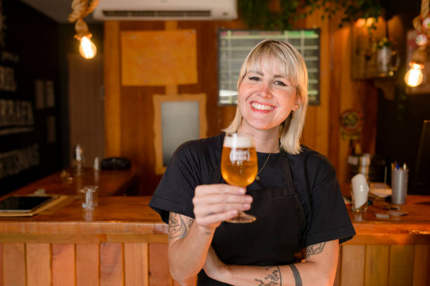 istock Young female brewer smiling holding tasting glass 1391709863