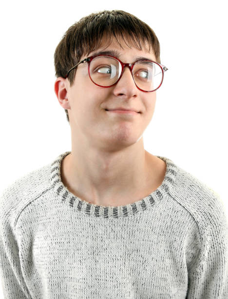 A closeup of a young man looking at the camera with raised eyebrows