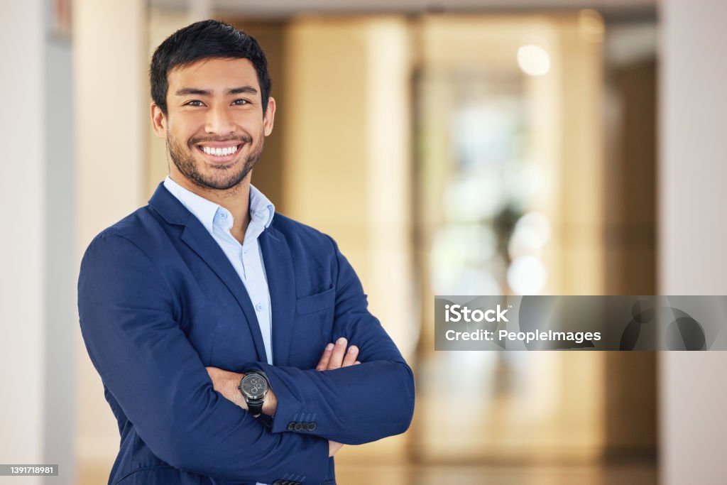 Portrait of a confident young businessman standing with his arms crossed in an office The more confident you are, the better you'll succeed Men Stock Photo