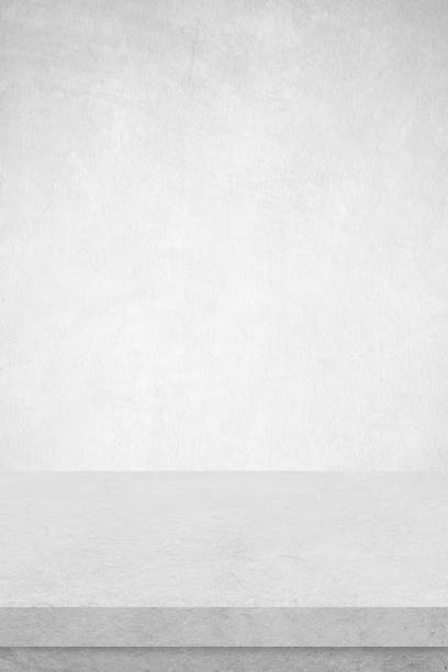 istock Empty white cement table over white cement concrete wall background, banner, table top, shelf, counter design for product display montage 1391719913