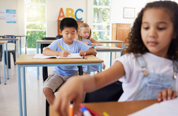 istock Shot of preschool students colouring in class 1391720637