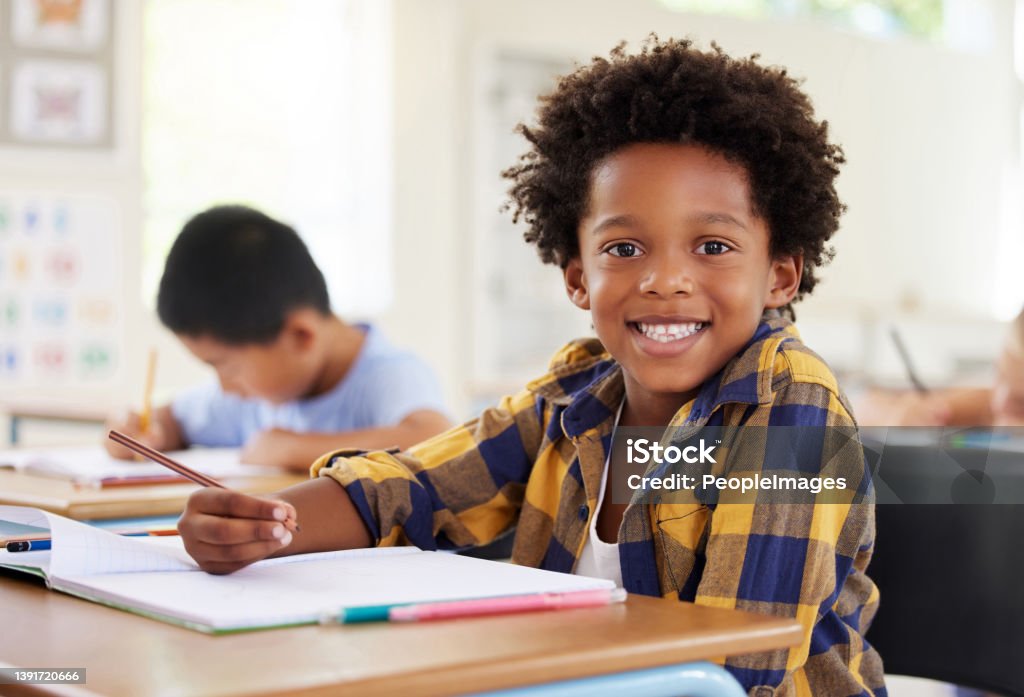 Shot of a preschooler colouring in class We love colouring Education Stock Photo