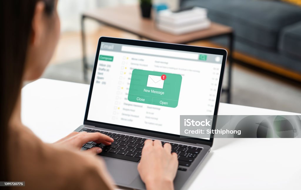 Woman using computer on table with new email message on laptop, communication connection message to global letters in the workplace E-Mail Stock Photo