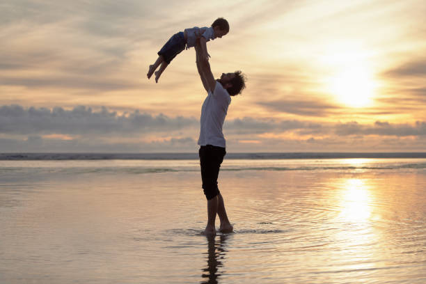 istock Shot of a father bonding with his son while at the beach 1391721056