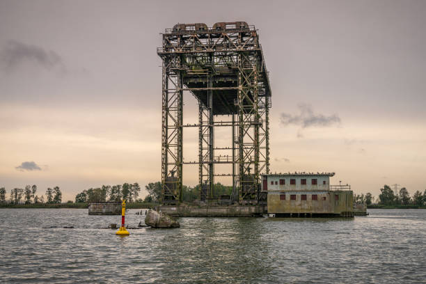 The derelict lift bridge in Karnin, Mecklenburg-Western Pomerania, Germany Karnin, Mecklenburg-Western Pomerania, Germany - October 08, 2020: The remains of the railway lift bridge baseball rundown stock pictures, royalty-free photos & images