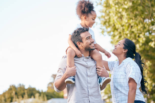 Shot of a young couple and their adorable daughter spending time together outdoors Happiness is having a loving and caring family lens flare offspring daughter human age stock pictures, royalty-free photos & images