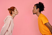 Profile of mixed race couple in love face each other, pout lips going to kiss, close eyes pleasure
