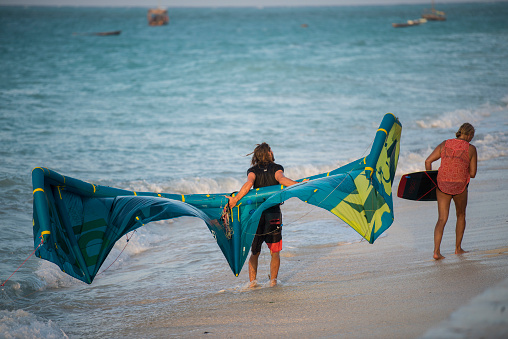 Zanzibar, Tanzania - January 02,2019: Tourists enjoy in kiteboarding on the sandy beaches of Zanzibar.
