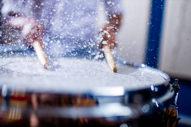Cropped image of a talented drummer hitting his drum skins hard at a gig. This concert was created for the sole purpose of this photo shoot, featuring 300 models and 3 live bands. All people in this shoot are model released.