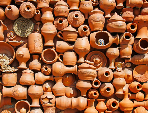 Background of handmade ceramic clay brown terracotta pots with names and initials