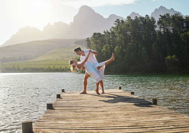 istock Shot of a young couple dancing while spending time at a lake 1391730253