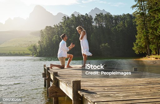 istock Shot of a young man proposing to his girlfriend in nature 1391730254