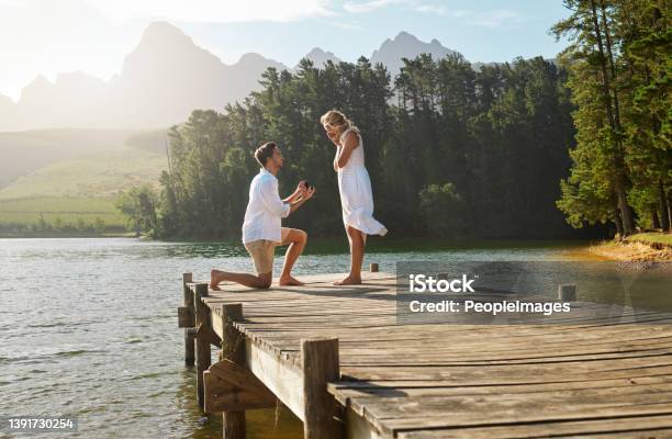 Shot Of A Young Man Proposing To His Girlfriend In Nature Stock Photo - Download Image Now