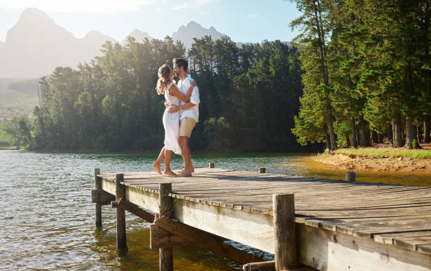 istock Shot of a young couple dancing while spending time at a lake 1391730259