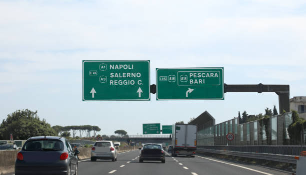 highway with the signs of the locations of southern italy naples salerno reggio calabria pescara and bari with cars running - salerno imagens e fotografias de stock