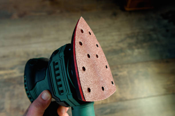 istock Sander machine in the hand and old texture wood 1391730384