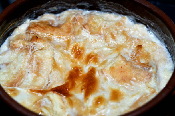istock Traditional Arabic Egyptian Eastern dessert cuisine called Om Ali, Egyptian Bread Pudding in a brown bowl pottery casserole 1391731341