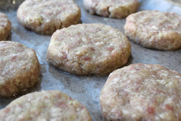istock Raw cutlets on parchment paper and on a baking sheet 1391732276