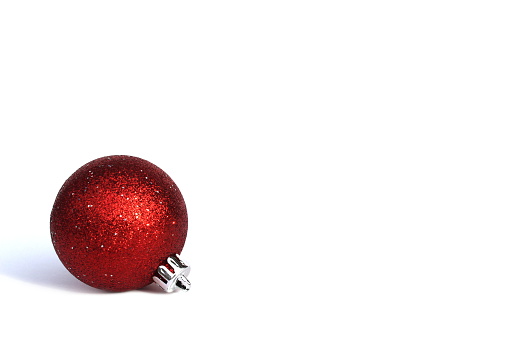 Red shiny ball on a christmas tree on a white background