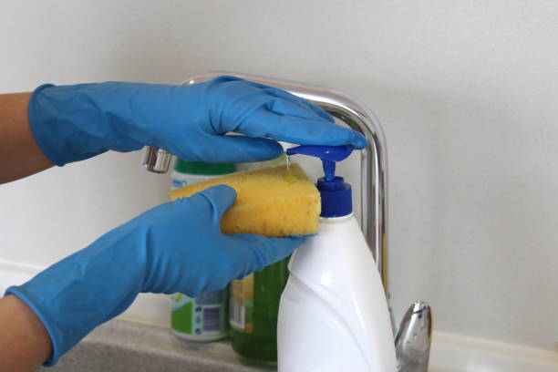 istock Hands in rubber gloves squeeze out dishwashing gel 1391736662