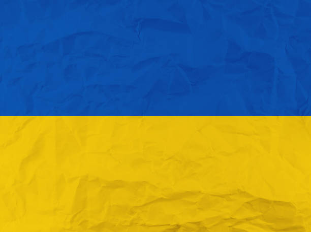 istock Crumpled blue and yellow paper texture with empty space. 1391737613