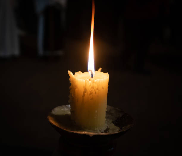 istock Holy Week Valladolid, candle lit with elongated flame during a procession at night 1391738800