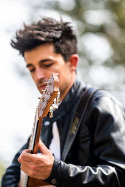 istock boy playing guitar outdoors in nature 1391738931