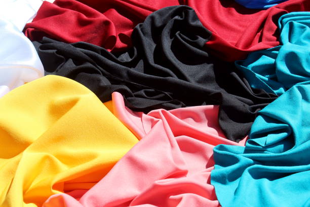 istock A bunch of different bright, multi-colored fabrics lie in one pile. 1391740153