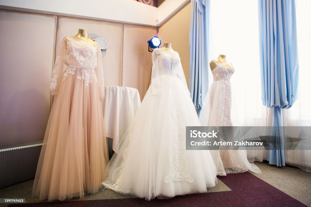 Wedding dresses presented on a fashion exhibition. Wedding dresses presented on a fashion exhibition Dressmaker's Model Stock Photo