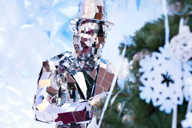 A man dressed in shiny mirrored costumes in New Year decorations.