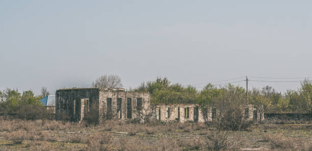 istock Old destroyed abandoned house in the field 1391742302