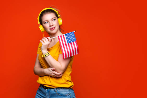 istock Girl holds small USA flag 1391744351