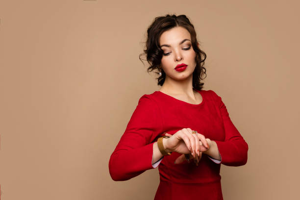 istock Woman looking at gold watch 1391744953
