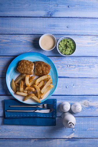 Traditional British meal of fish & chips with mushy peas.