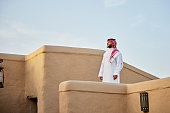Mid adult Saudi man standing outdoors amidst At-Turaif ruins
