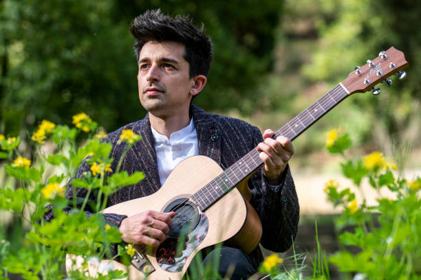istock boy plays guitar surrounded by nature 1391746661