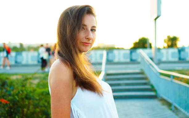 istock Young woman at sunset. 1391748935