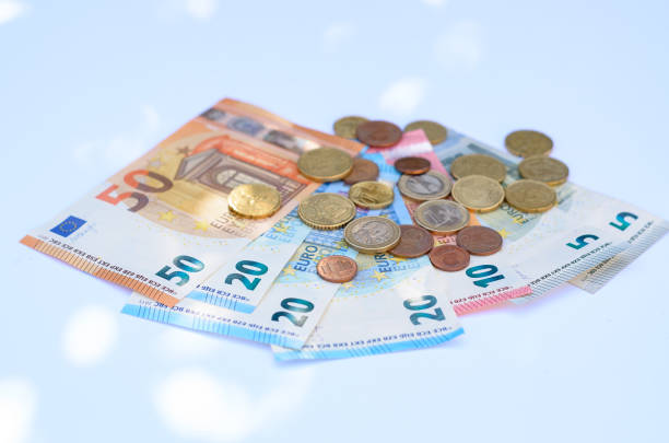 Money and coins on a light blue background