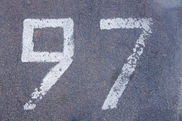 istock number ninety seven painted in white paint on the pavement 1391750093