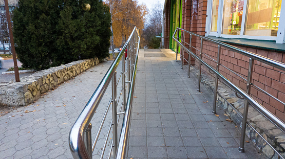 Sidewalks and wheelchair ramps at the entrance to the store during the day