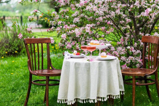 istock Festive spring romantic table setting with dessert in blossom garden. Easter table concept. Family dinner. 1391751576
