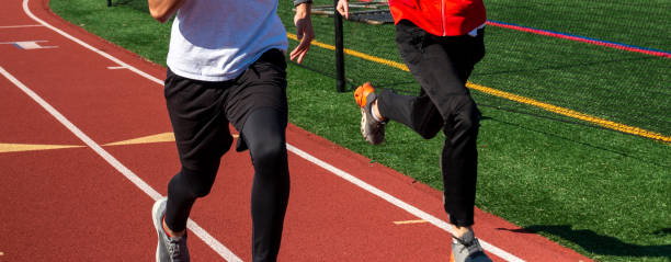 istock Boys running fast on a track two by two 1391755249