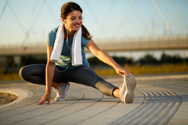 istock Young sporty woman doing stretching exercise on running track 1391758233