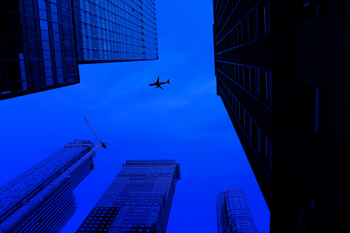 Flying commercial airplane over cityscape of New York