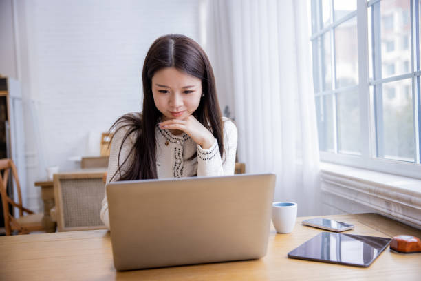 istock Young  businesswomen working with laptop by window 1391759323