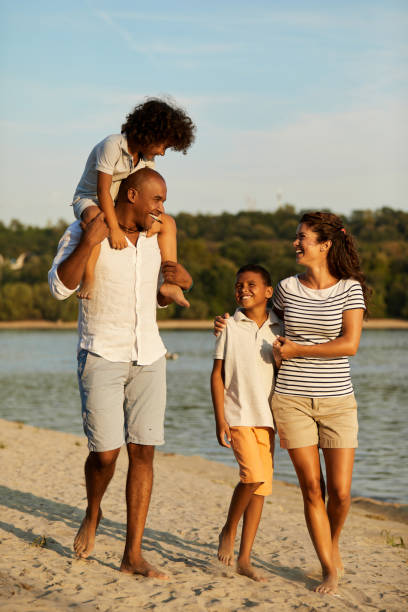 istock Beautiful family walking on the beach 1391759403