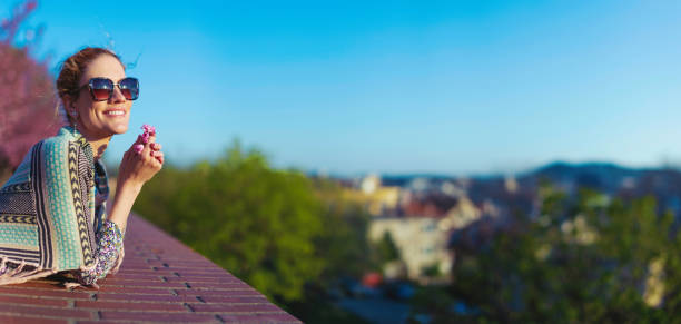 Happy young carefree woman enjoying spring panorama with toothy smile, widescreen banner with empty space