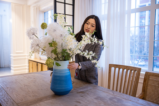 Women arrange flowers at home