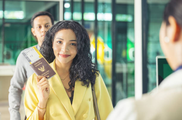 istock At the airport check-in counter, a passenger hands over his documents to the manager via a counter ticket. 1391761875