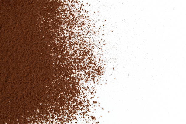 Scattered cocoa lies on a white background with space for text.